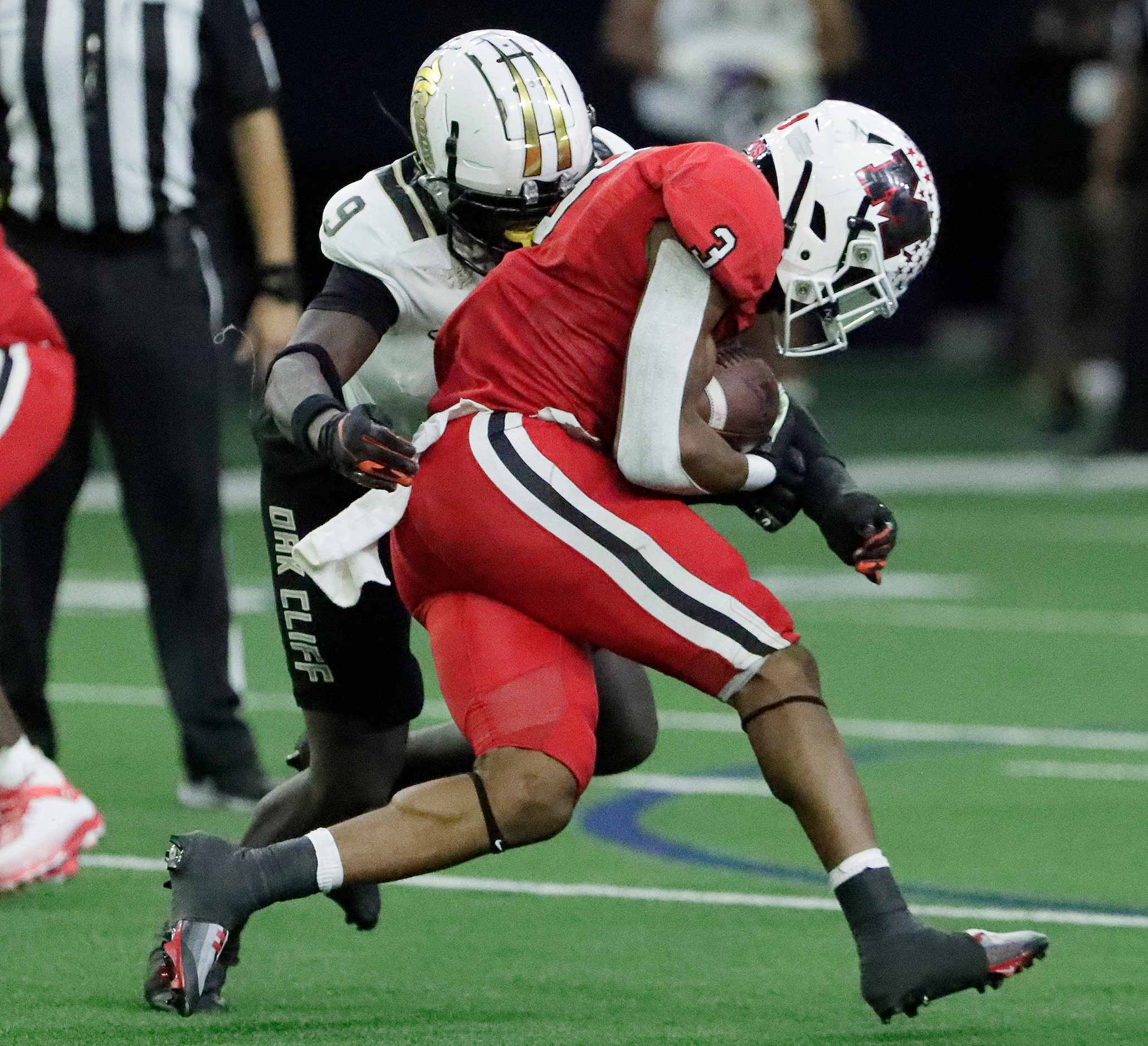 Melissa High School running back Nathan Adejokun (3) is tackled by South Oak Cliff High...