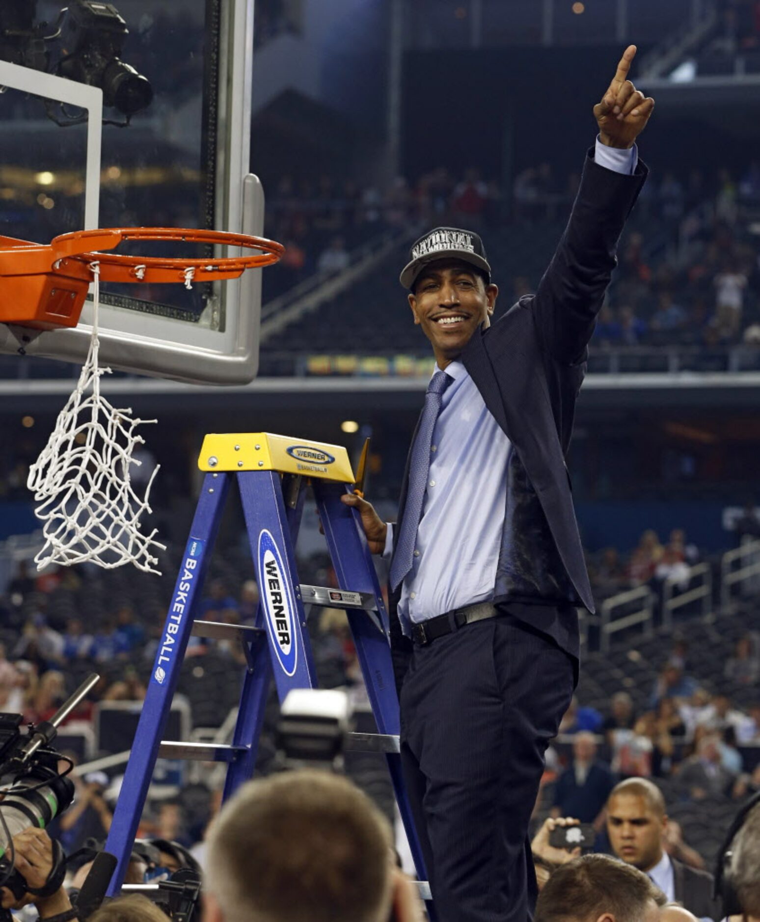 Connecticut Huskies head coach Kevin Ollie cuts the net  after defeating the Kentucky...