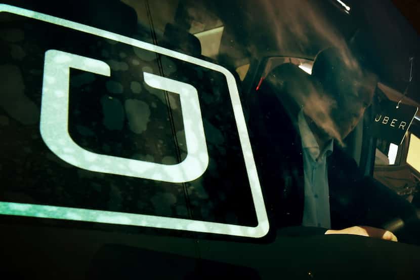 A man checked out a vehicle at the first of Uber's Work On Demand recruitment events in Los...