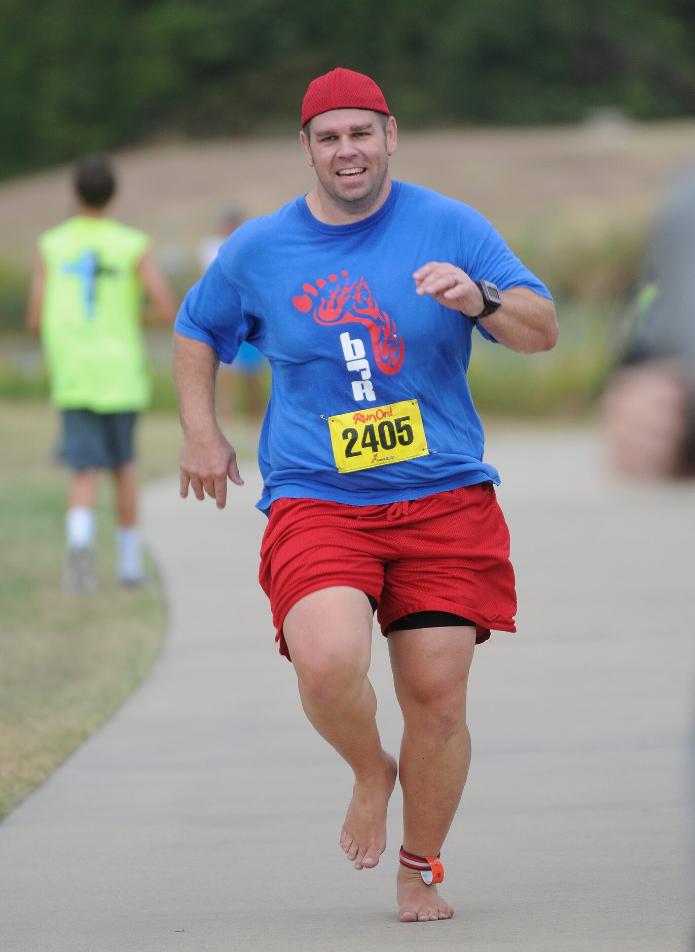 Brian Myers finishes the CiCi's Pizza Barefoot Run.