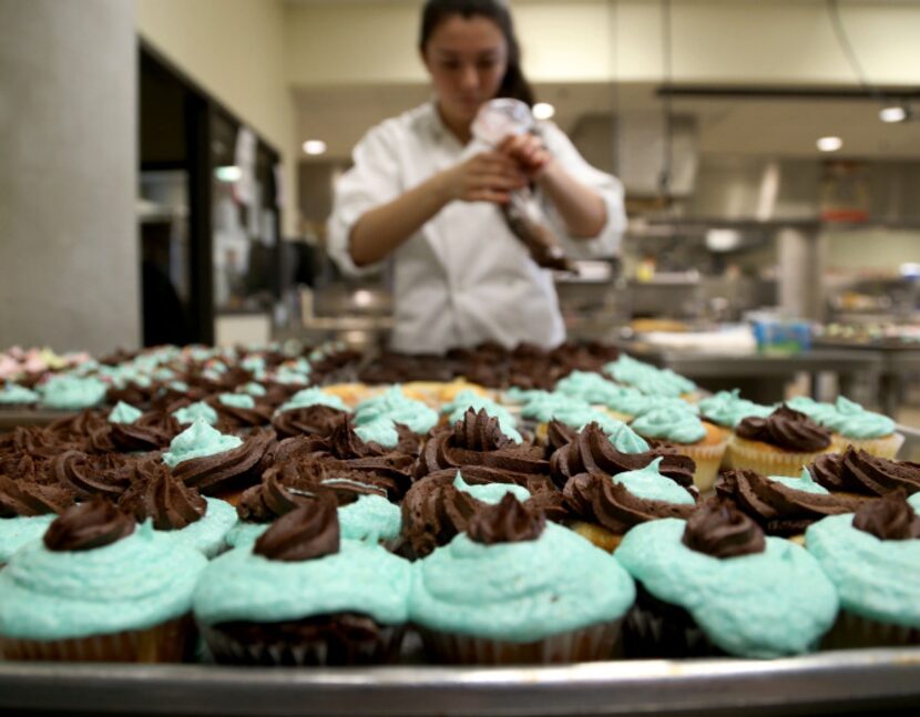 Culinary Arts student Sonia Martinez prepares cupcakes to sell in the school coffee shop...