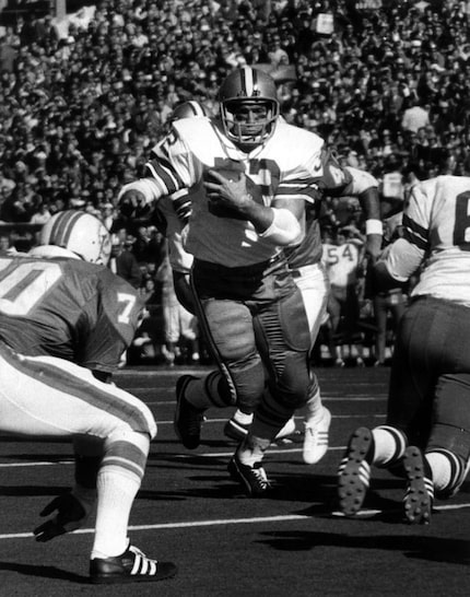 Dallas Cowboys' Walt Garrison crashes through the Miami line for a 14-yard gain during the...