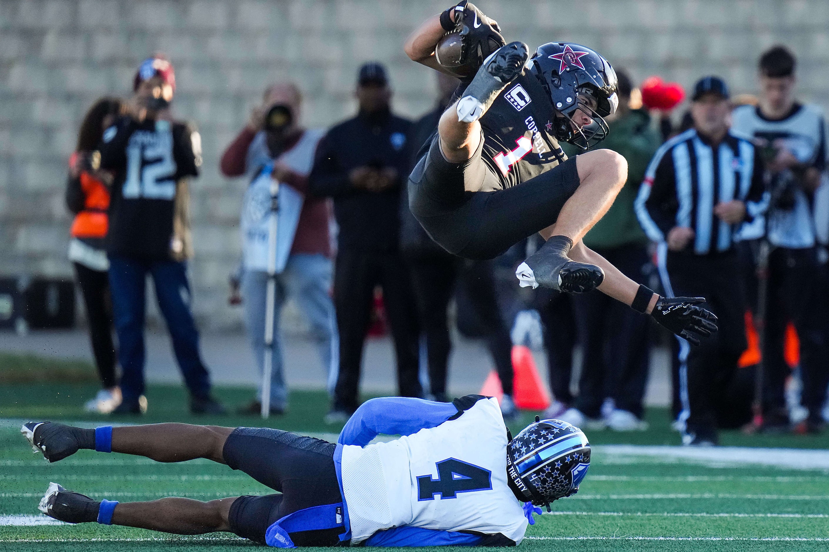 Coppell wide receiver Tucker Cusano (1) is knocked off his feet by North Crowley’s Draden...