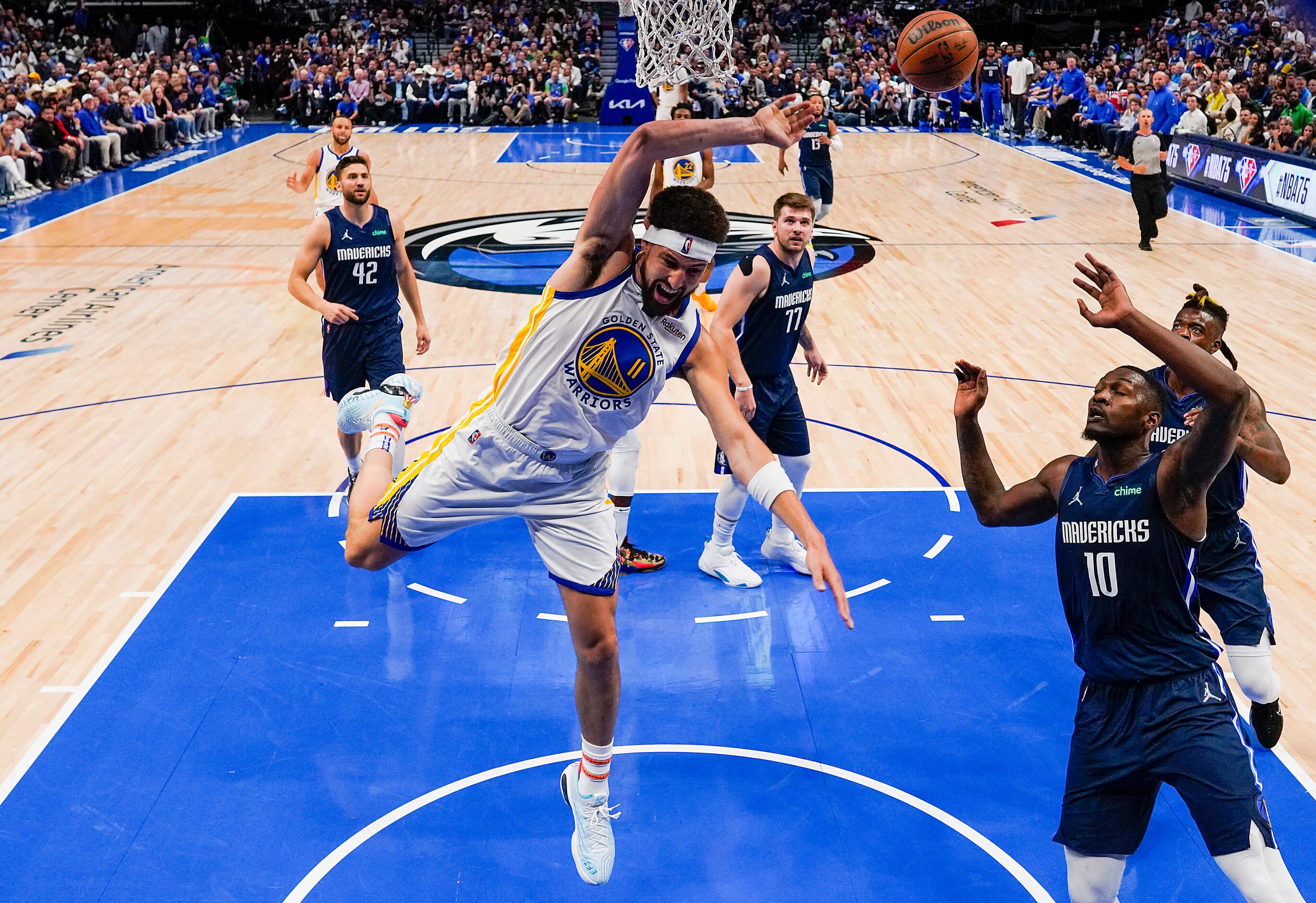 Golden State Warriors guard Klay Thompson (11) is fouled by Dallas Mavericks forward Dorian...