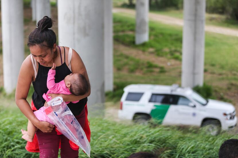 Central American asylum-seekers turn themselves in to Border Patrol after crossing the Rio...
