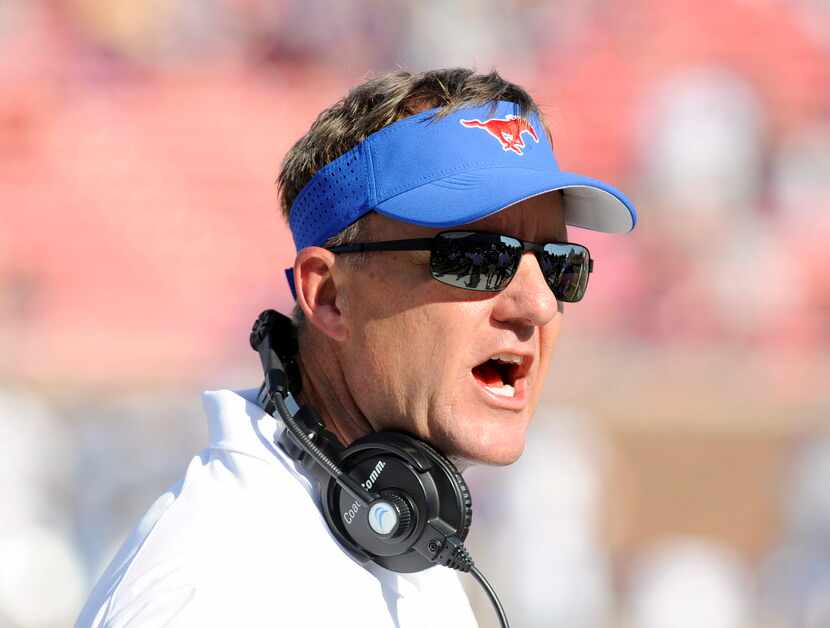 SMU Mustangs head coach Chad Morris gives instructions to his team in the first half during...