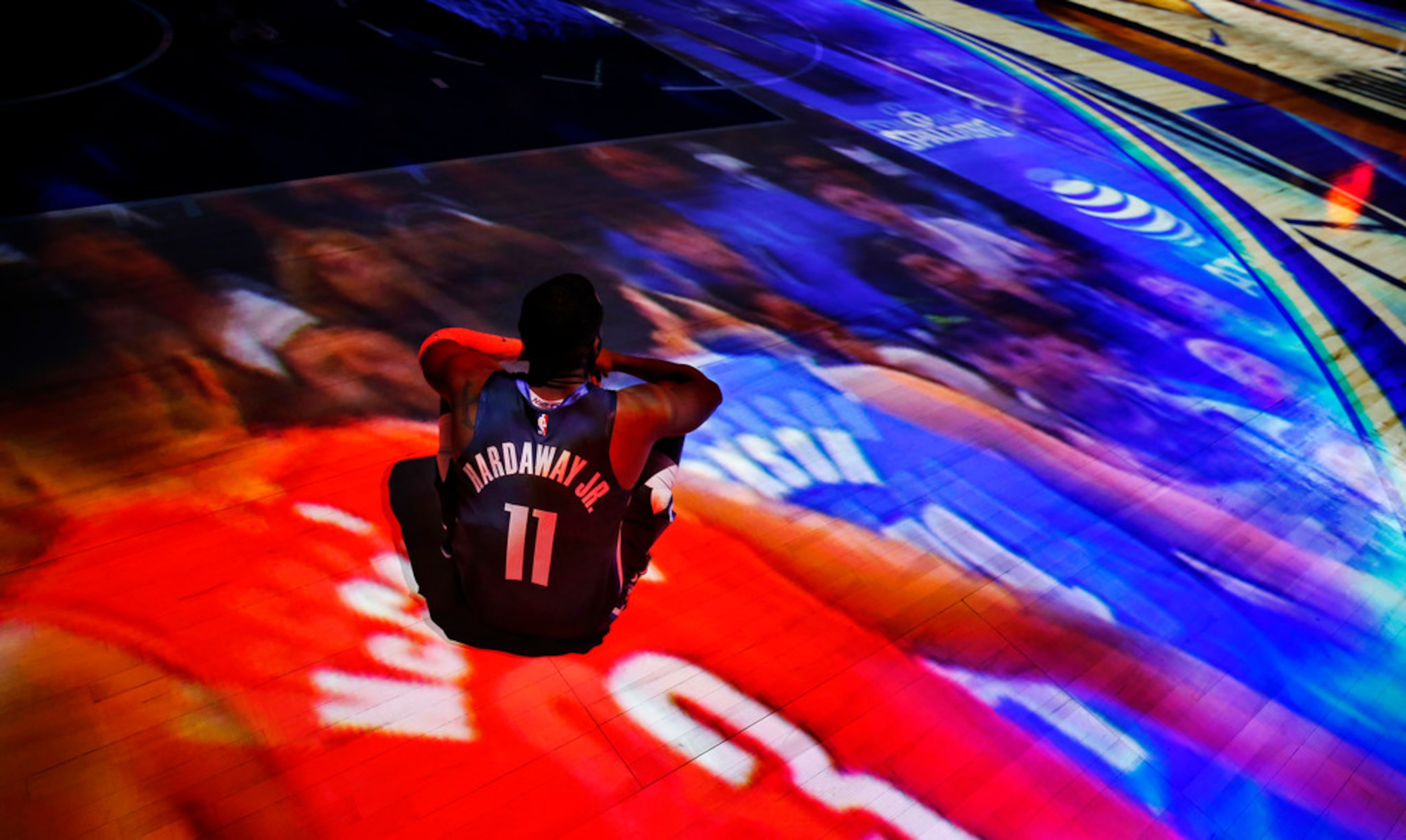 Dallas Mavericks guard Tim Hardaway Jr. (11) watches a video projection on the floor before...