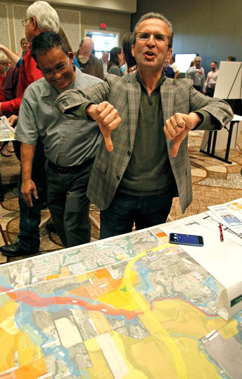 TxDOT professional engineer Nazrul Chowdhury (left) looks on while McKinney property owner...