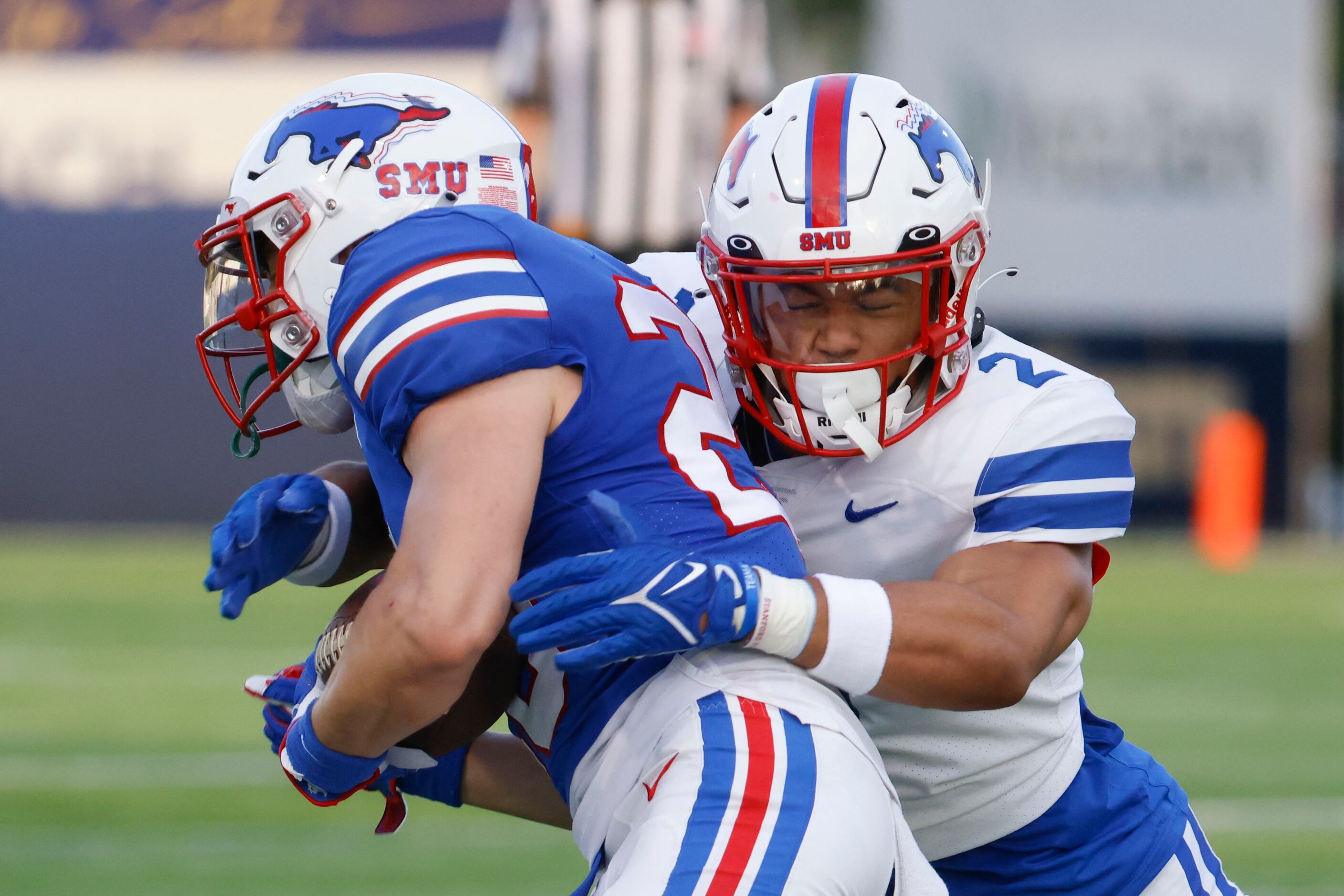 Southern Methodist wide receiver Jayleen Record (left) gets tackled by Southern Methodist...
