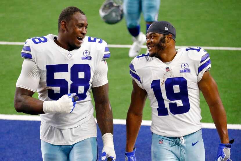 Dallas Cowboys defensive end Aldon Smith (58) and wide receiver Amari Cooper (19) laugh as...