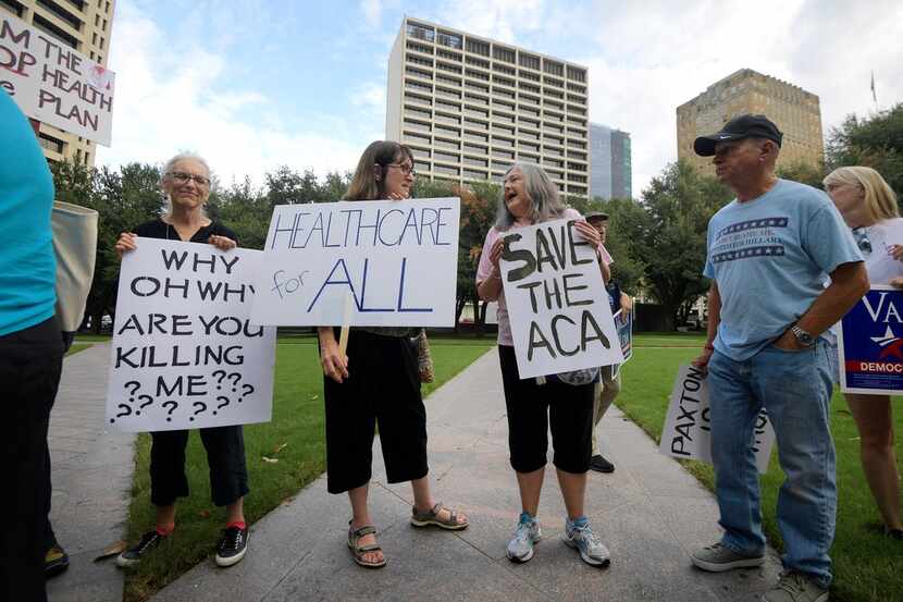 Supporters of the Affordable Care Act protest during a rally at Burnett Park in Fort Worth...