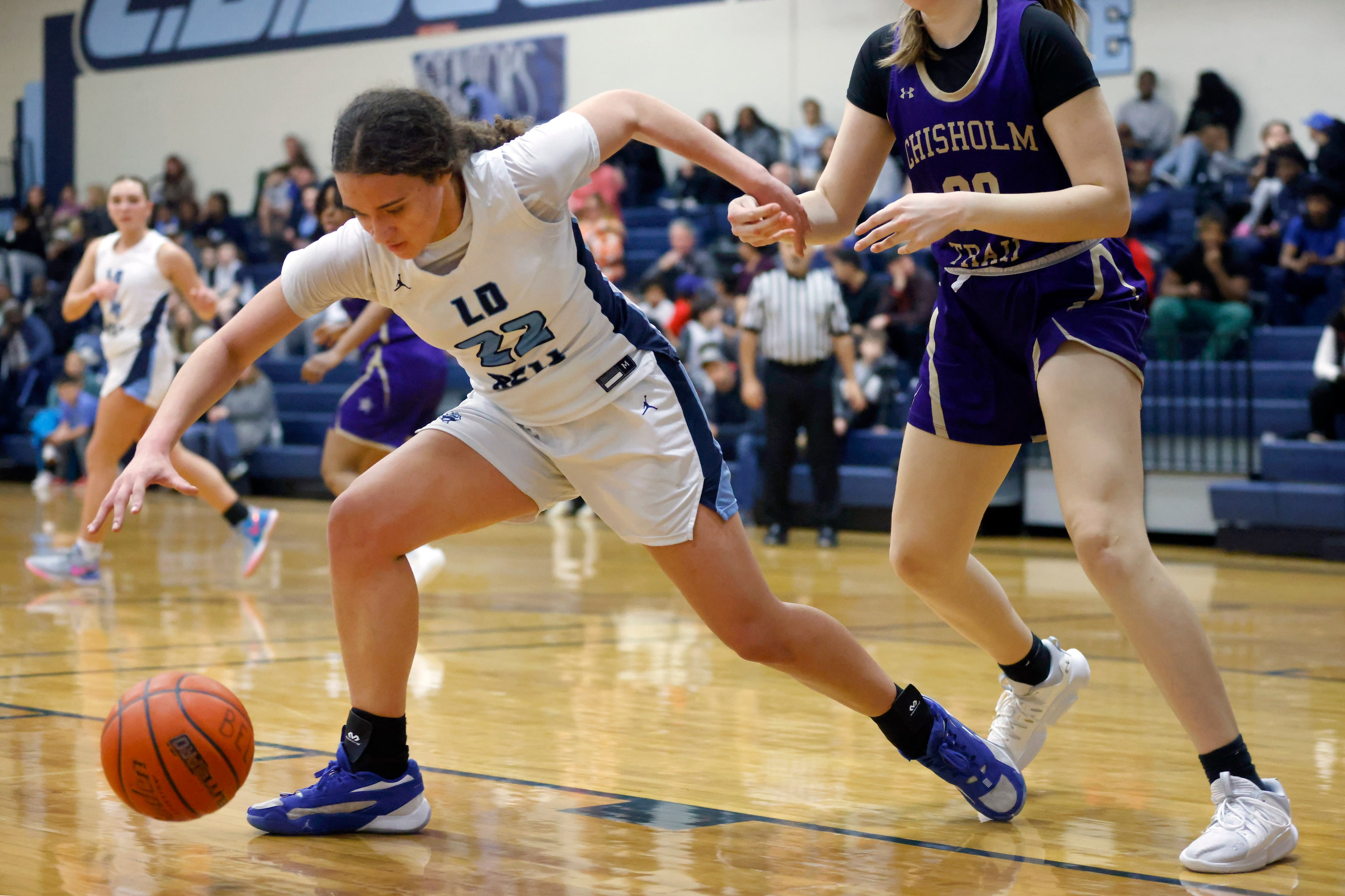 Hurst L.D. Bell’s Chanelle Davis (22) reaches for an offensive rebound against Saginaw...