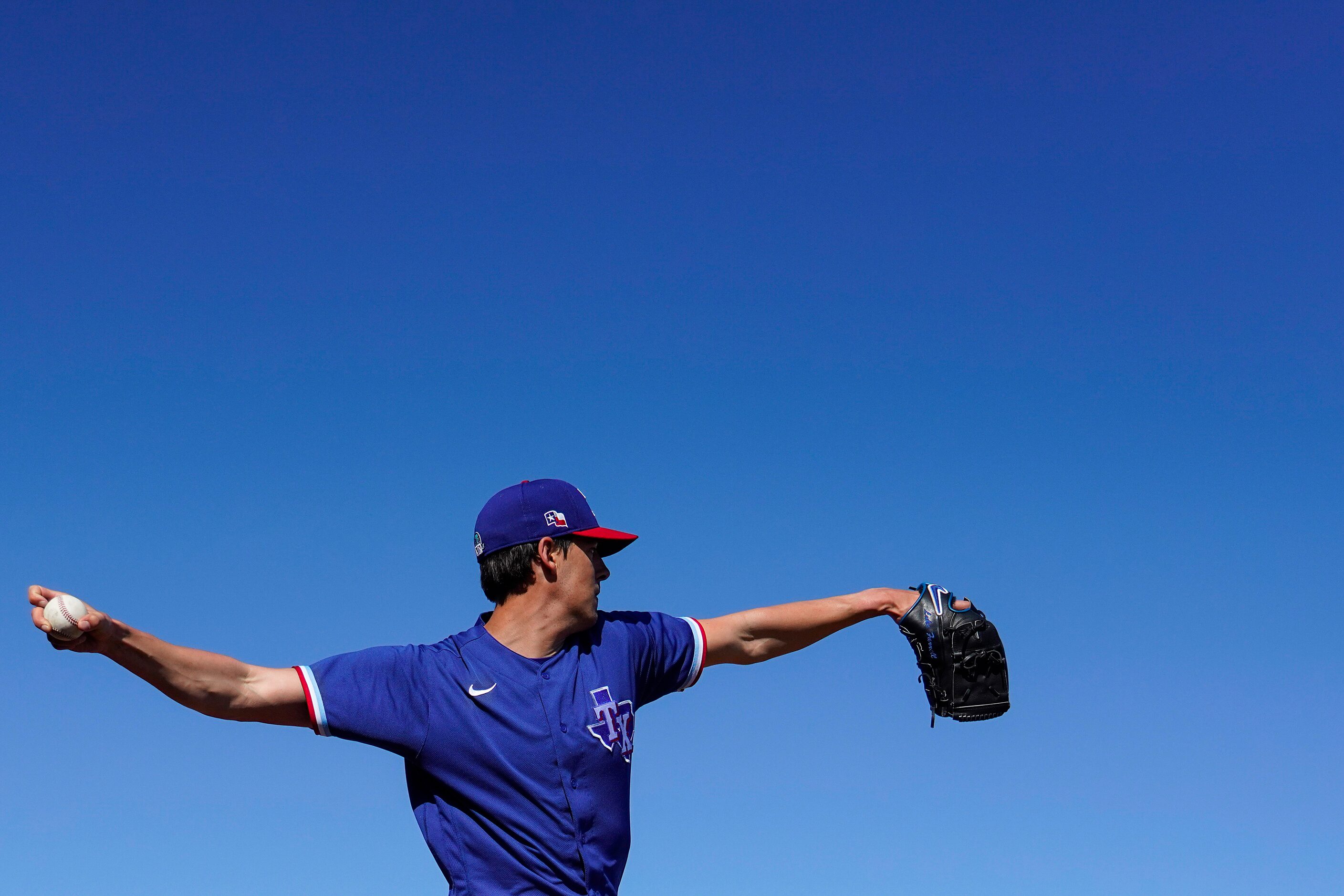 Texas Rangers pitcher Luke Farrell throws in the bullpen during a spring training workout at...