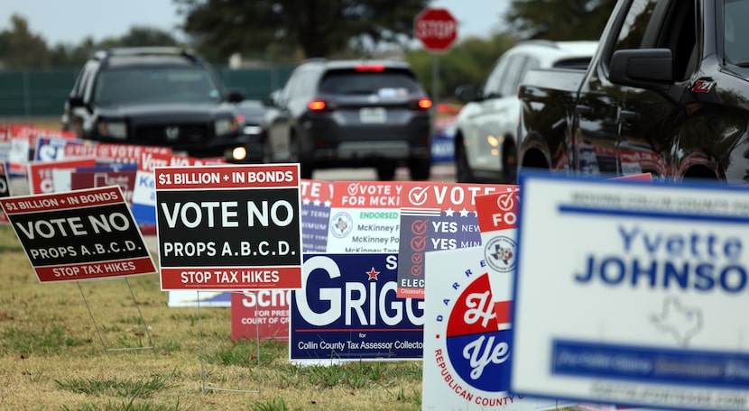 Area residents drive past a sea of campaign posters during early voting in Collin County at...