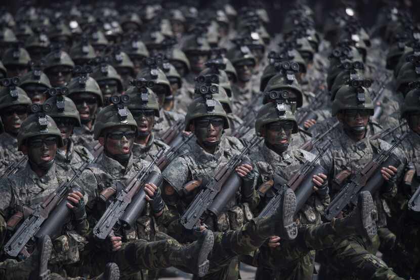 Korean People's Army soldiers march through Kim Il-Sung square during a military parade...