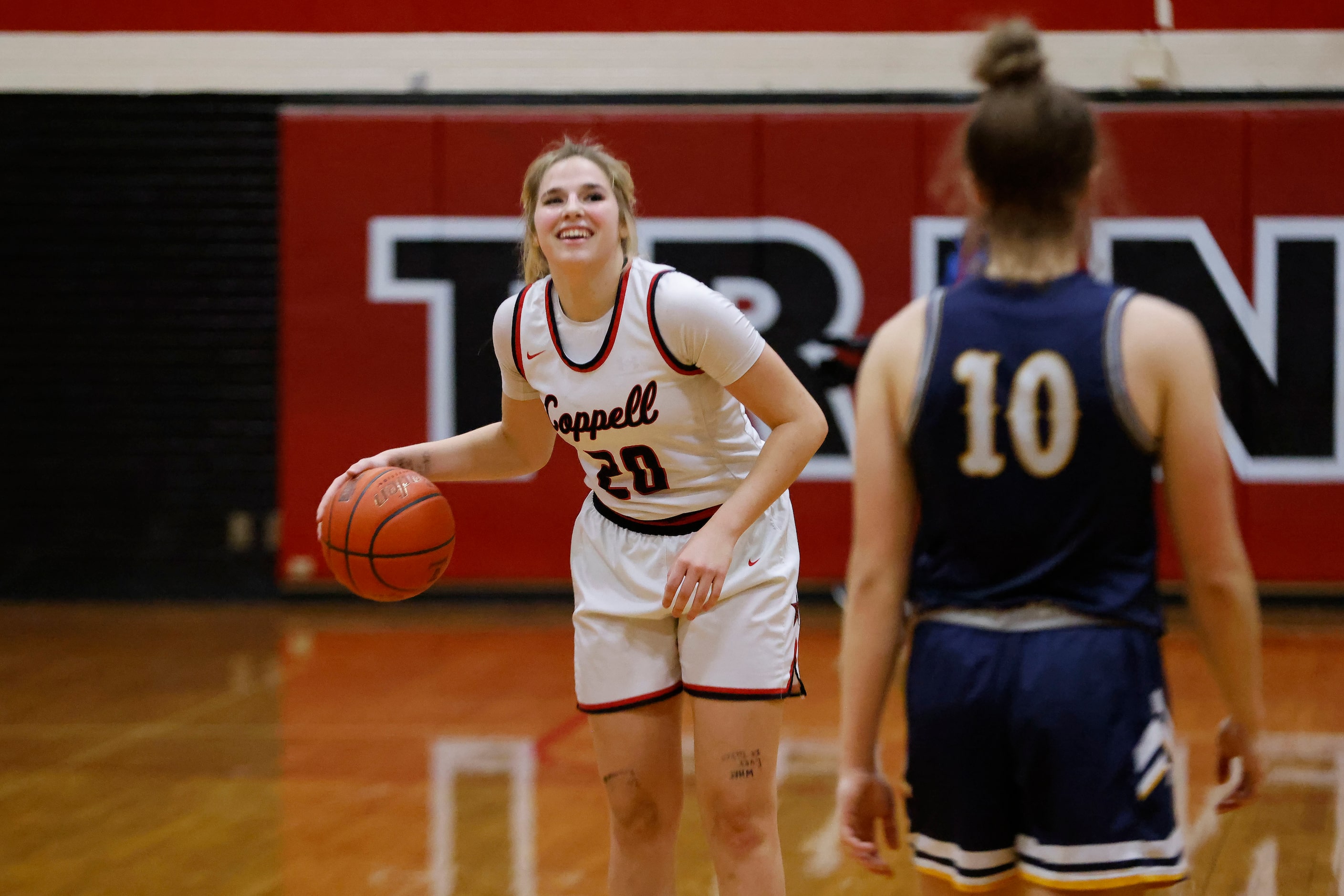 Coppell’s Jules LaMendola (20) smiles as the closing seconds tick off the clock in front of...