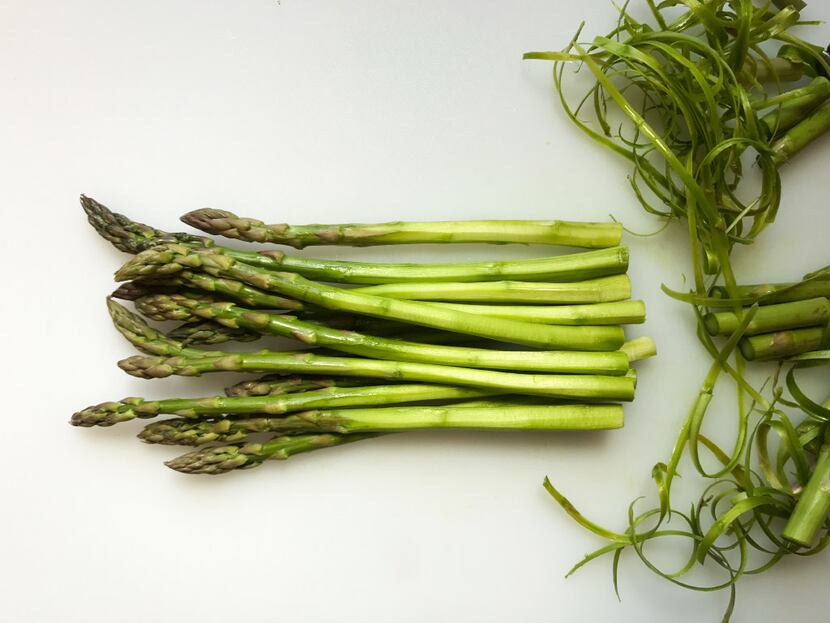 To prepare asparagus before poaching, trim off the woody ends and peel each spear about...