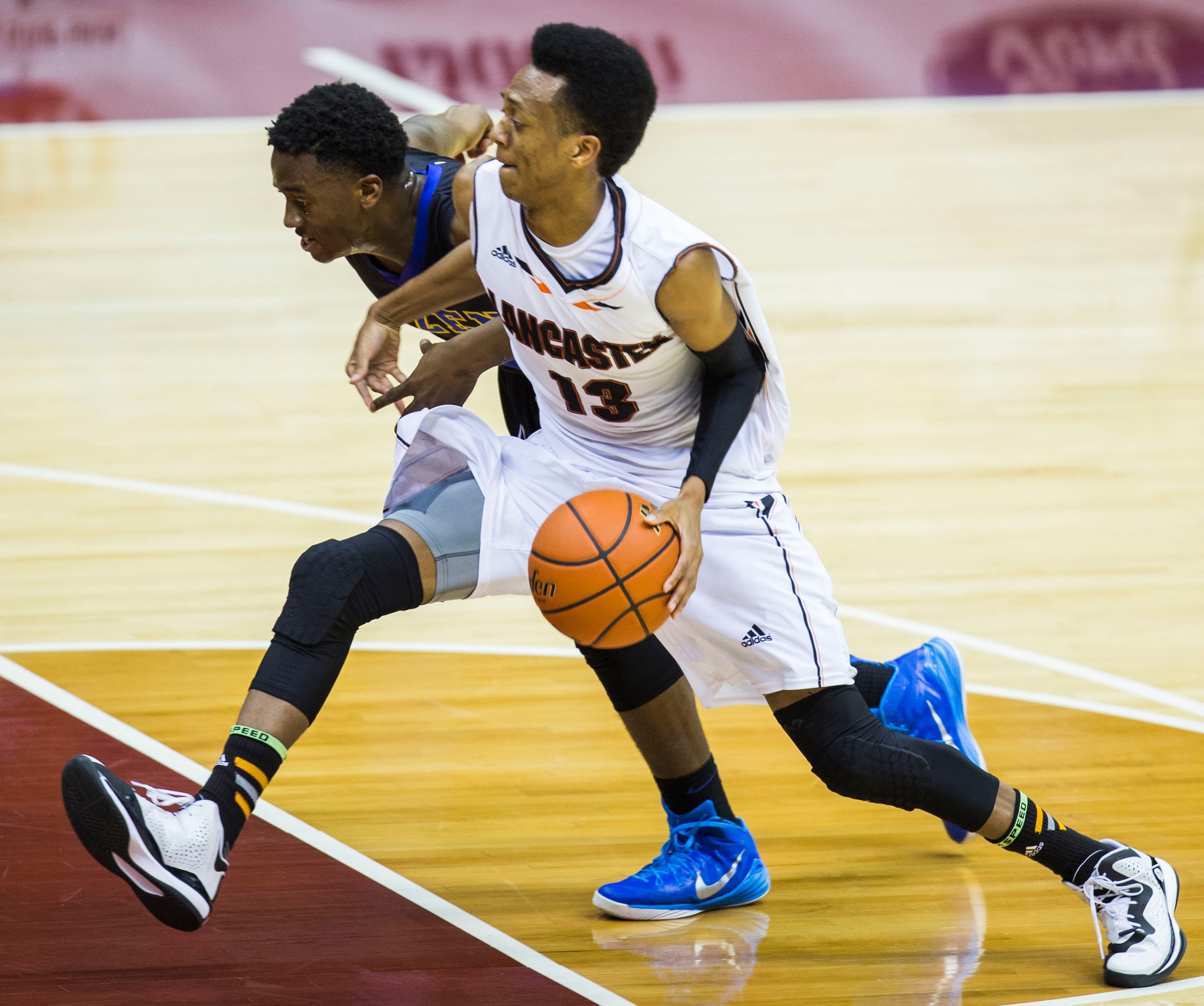 Lancaster guard Antwon Portley (13) makes his way around Beaumont Ozen guard/forward Joshua...