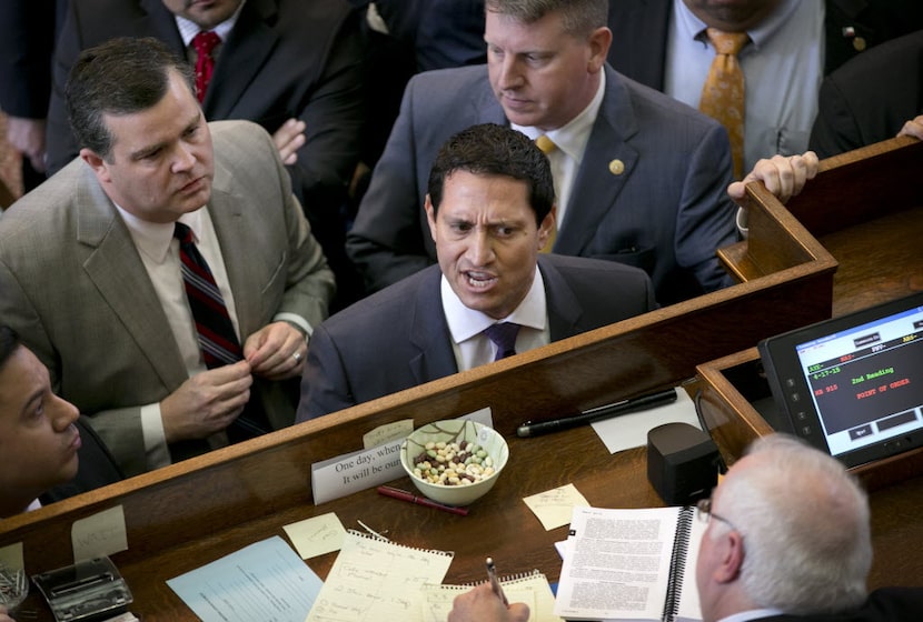 Rep. Trey Martinez Fischer (center) says he strongly favors regulating large companies such...