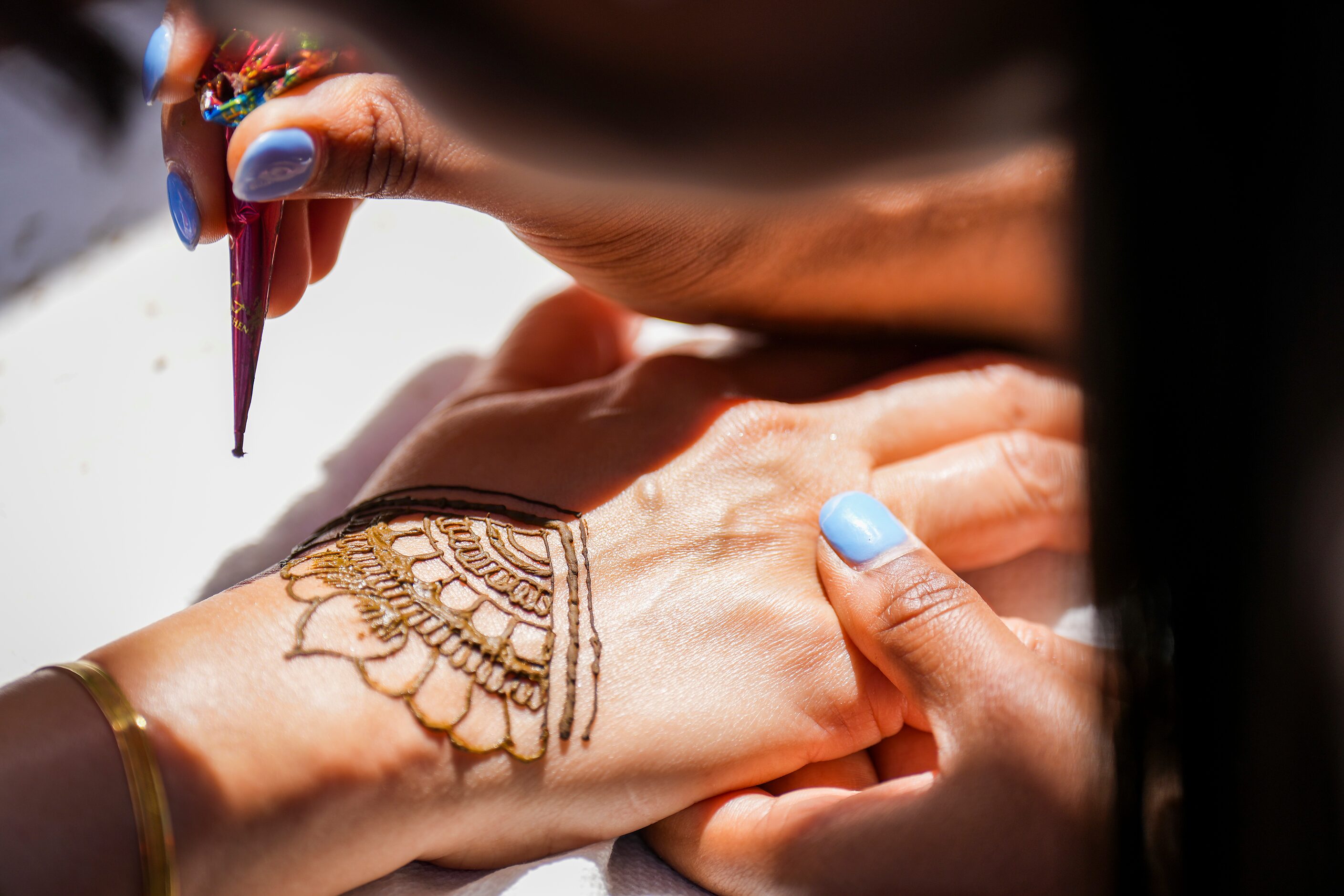 Orit Otzker of Keller get a henna tattoo during the Festival of Joy on Saturday, April 15,...