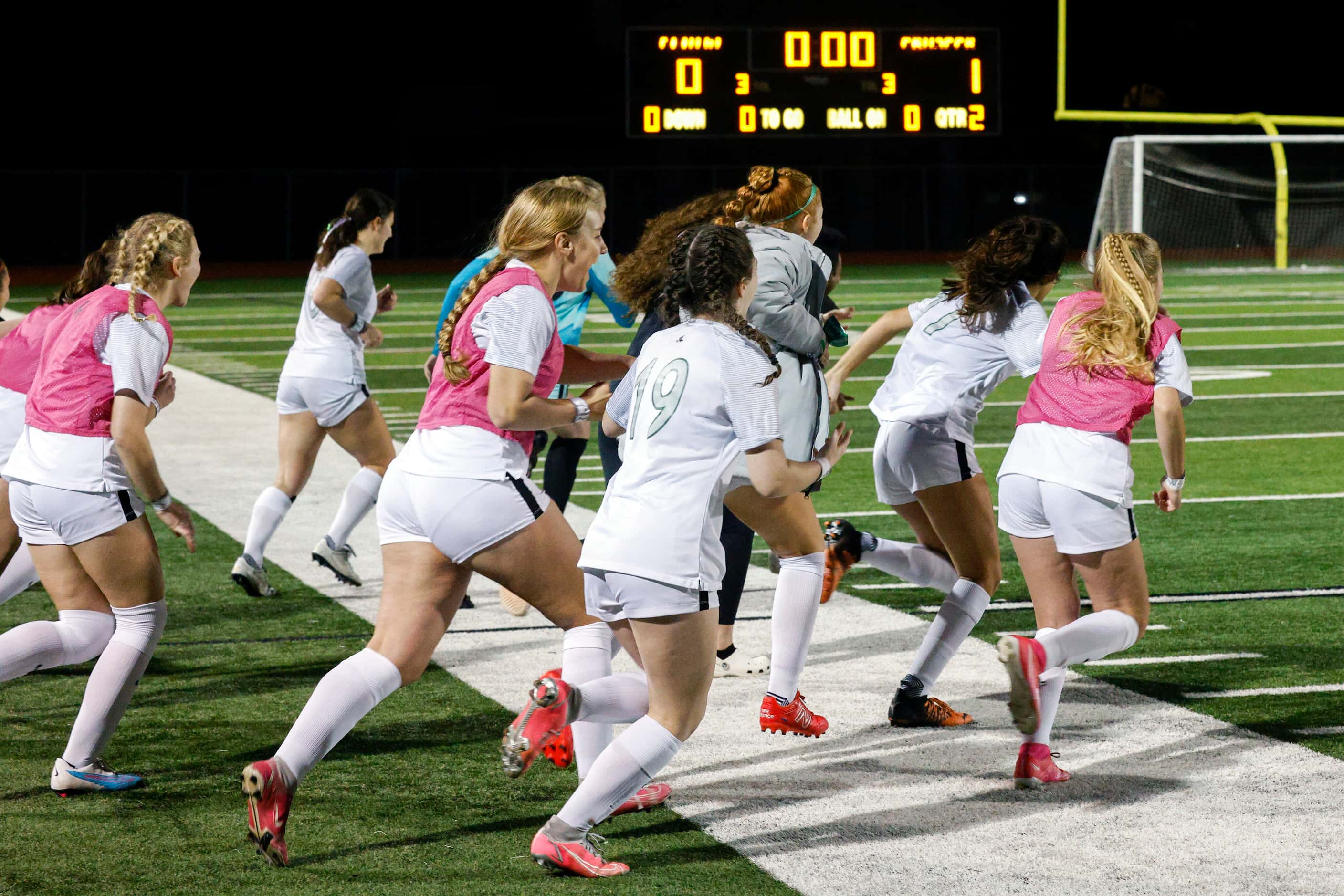 Prosper players rush the field after winning a UIL 6A bi-district playoff game against...