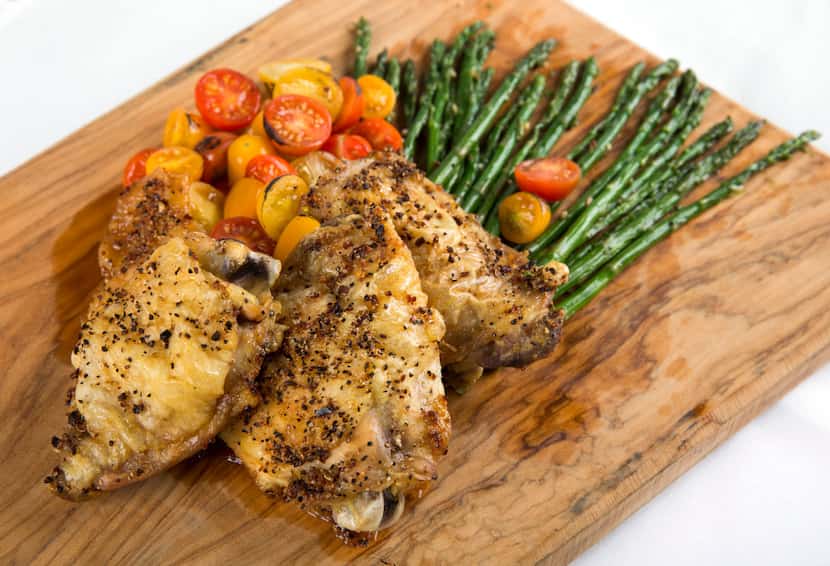 Oven baked chicken thighs with roasted asparagus and cherry tomatoes