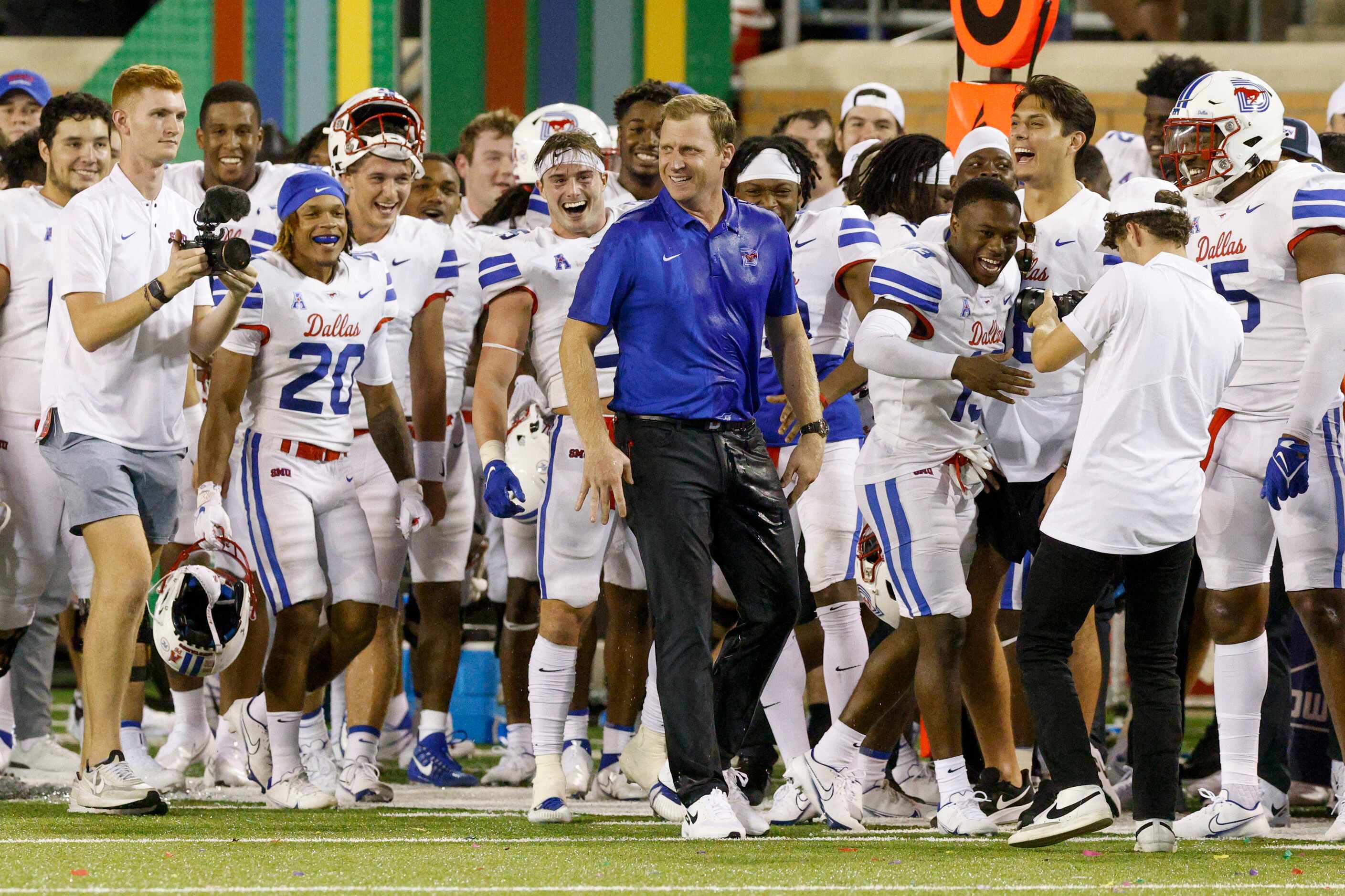 SMU head coach Rhett Lashlee smiles after being doused with ice water after a win against...