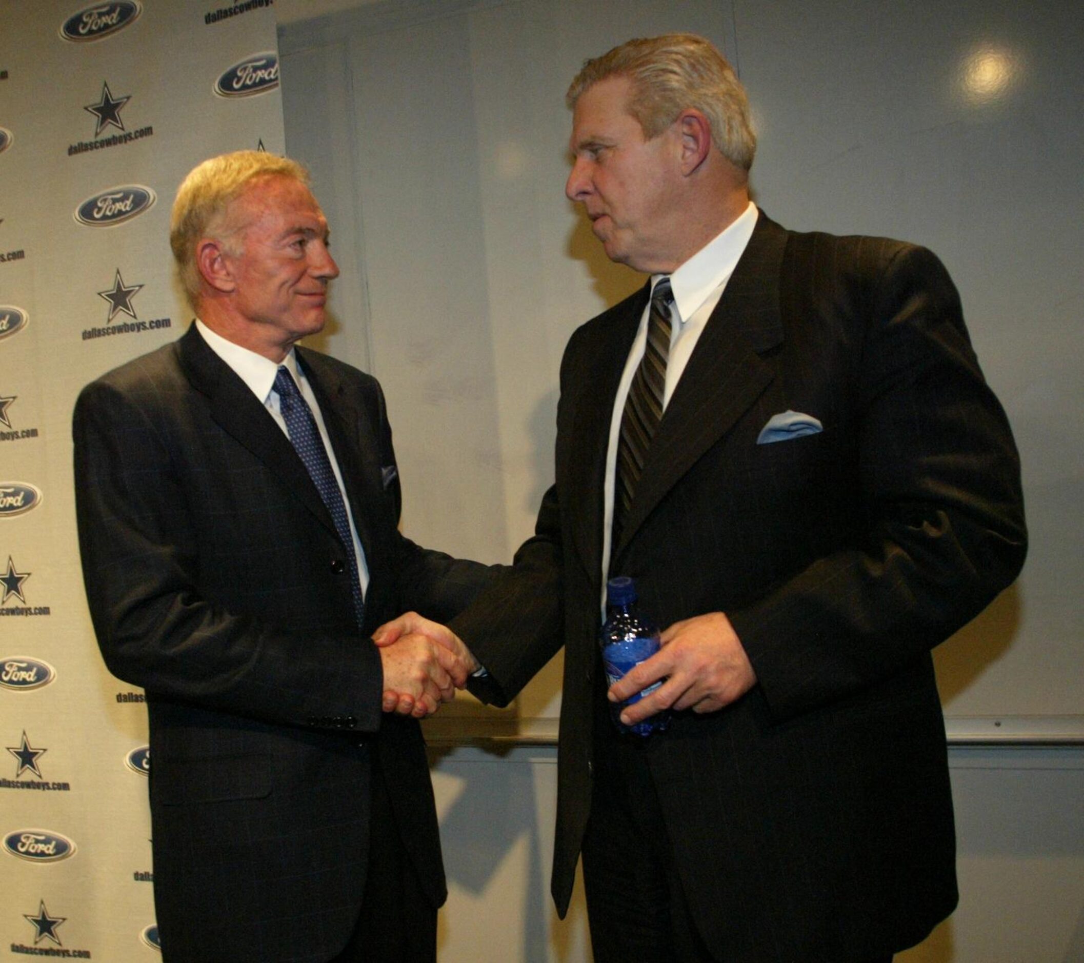 Cowboys owner Jerry Jones (left) shakes hands with his new head coach, Bill Parcells...