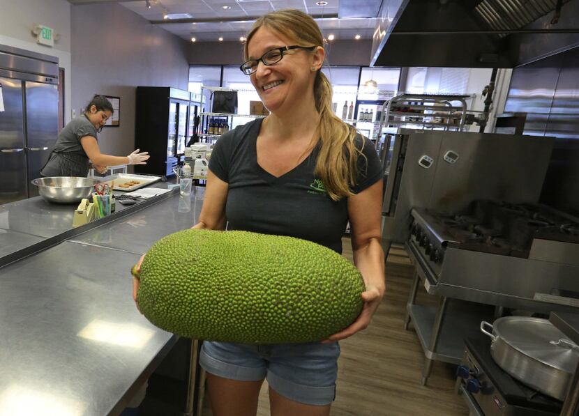 Marianne Lacko carries a jackfruit to the counter to prepare it in a recipe at Nature's...