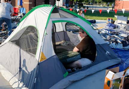 Don Ford of Dallas blows up an air mattress in his tent during the grand opening of...