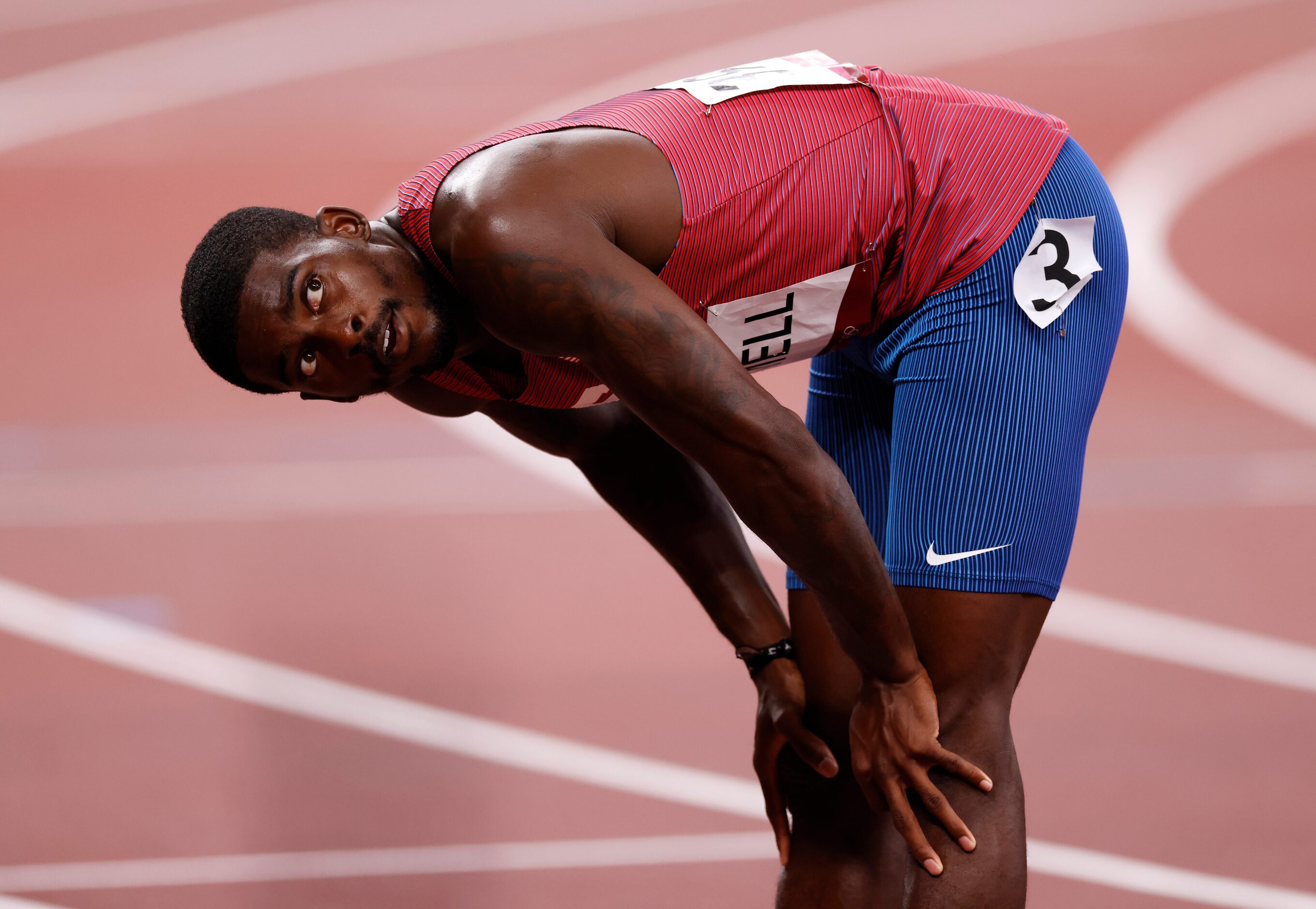 USA’s Trayvon Bromell waits for the official time for his run in the men’s 100 meter...