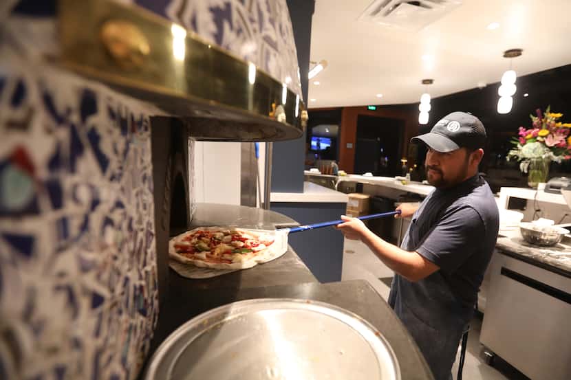 Isai Rios makes a pizza at Partenope in Richardson, which opened in November 2023.