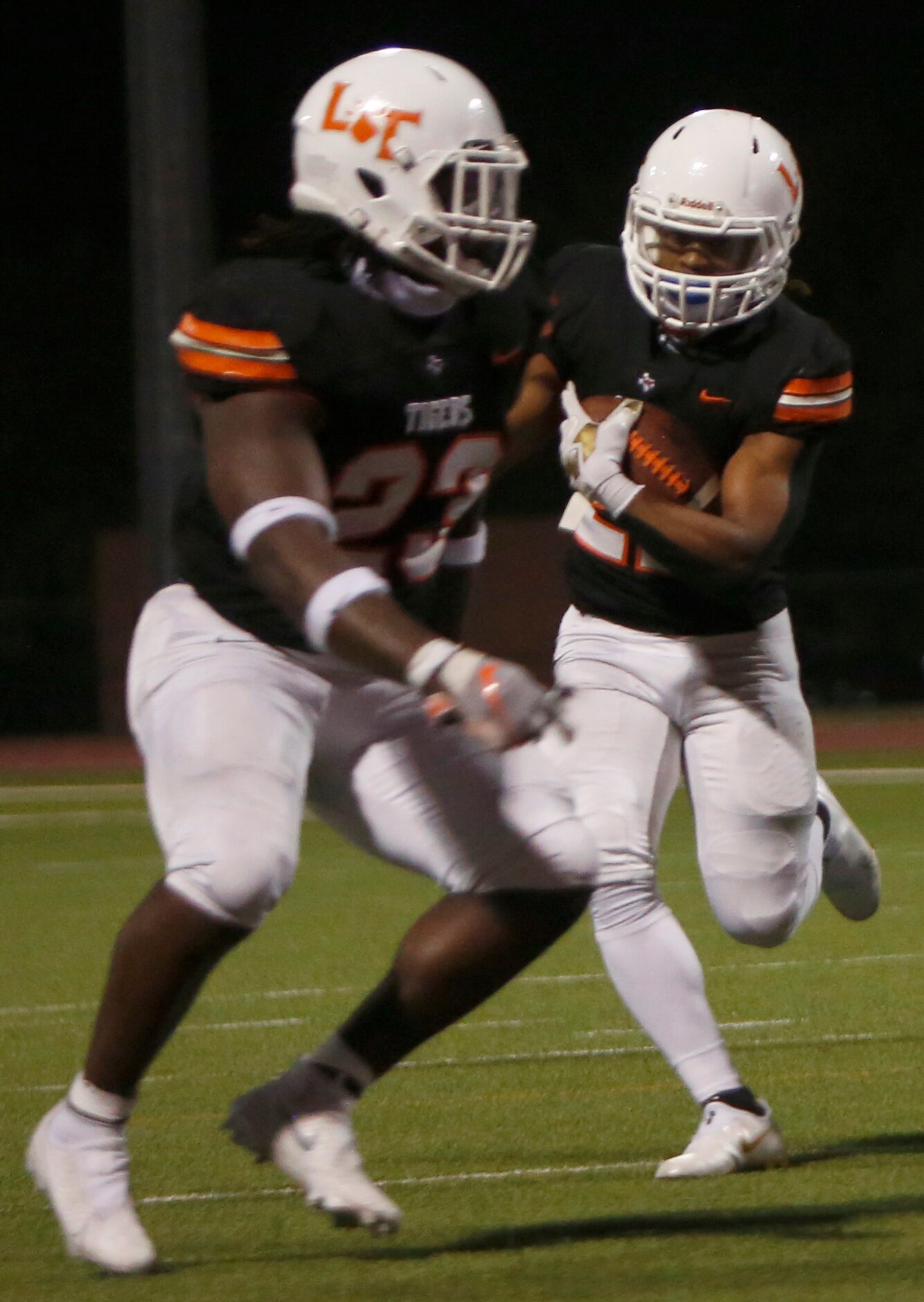 Lancaster running back Maurice Moore (22) follows the block of tight end Desmond Frazier...