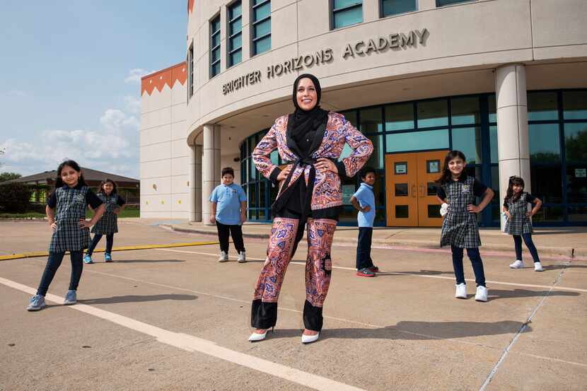 Alaa Ammuss, 31, of Plano, an alumna of Brighter Horizons Academy in Garland, is surrounded...