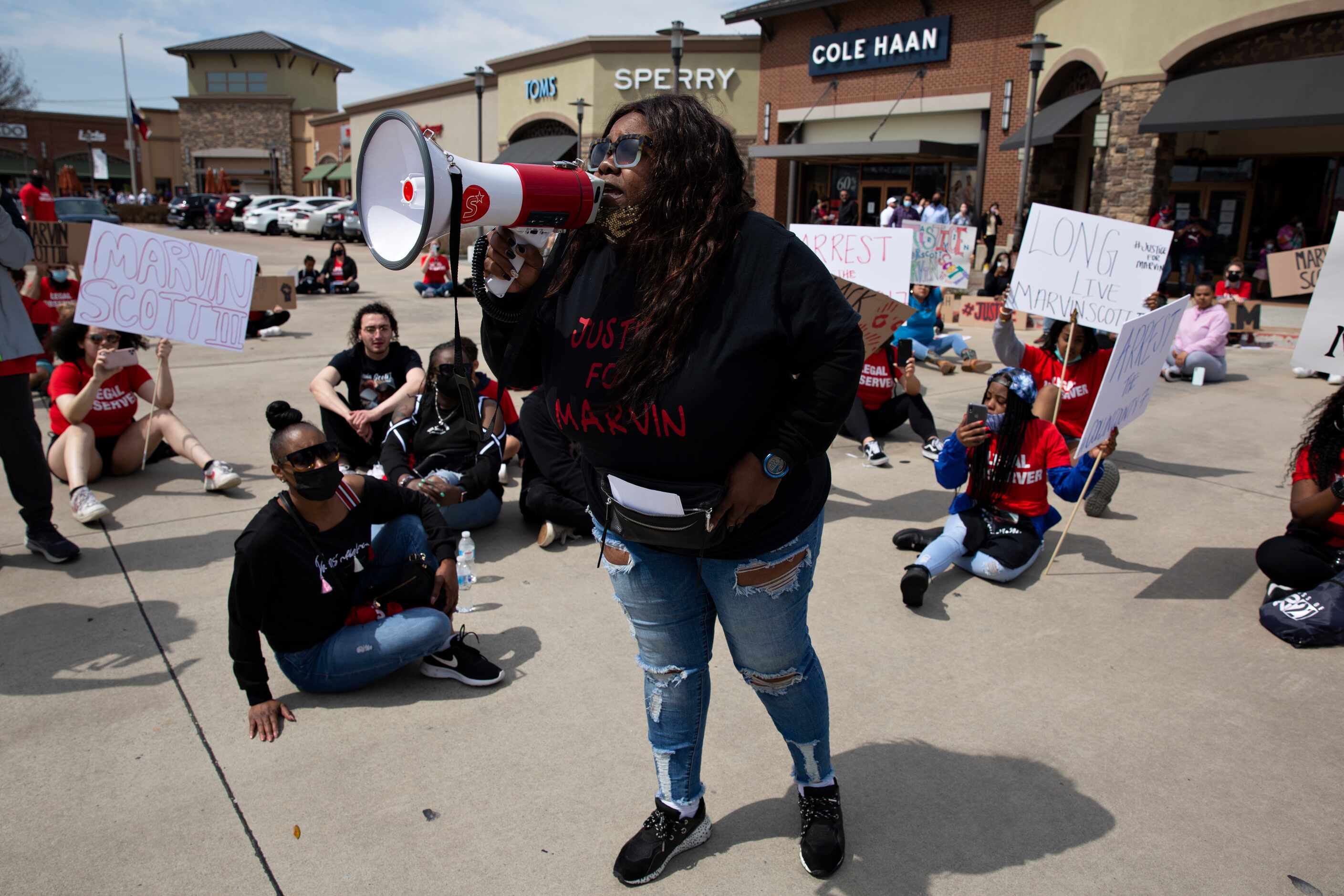 LaSandra Scott leads a chant in the Allen Outlets on Sunday, March 21, 2021 demanding...