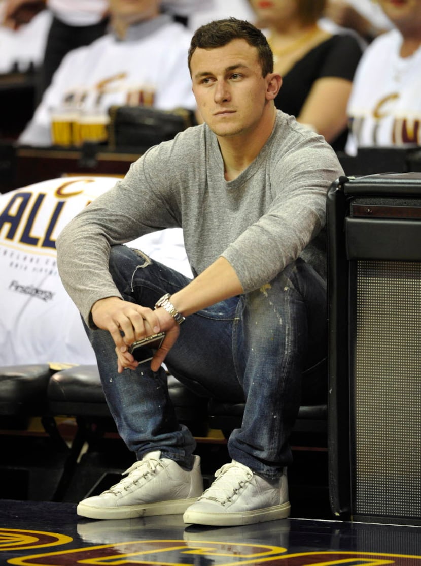 Apr 19, 2015; Cleveland, OH, USA; Cleveland Browns quarterback Johnny Manziel sits in the...