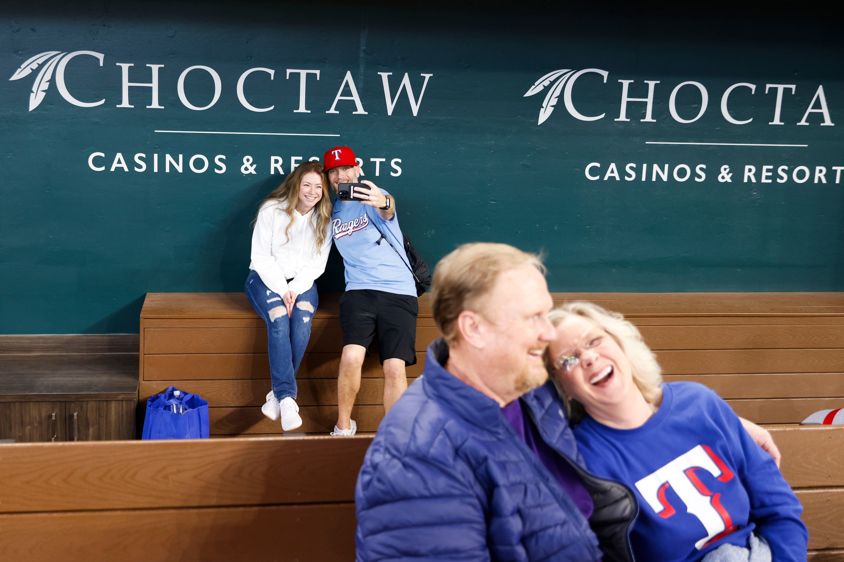 Michael Swan (back right) takes a photo with Katie Swan as Cindy McCoy (front right) shares...