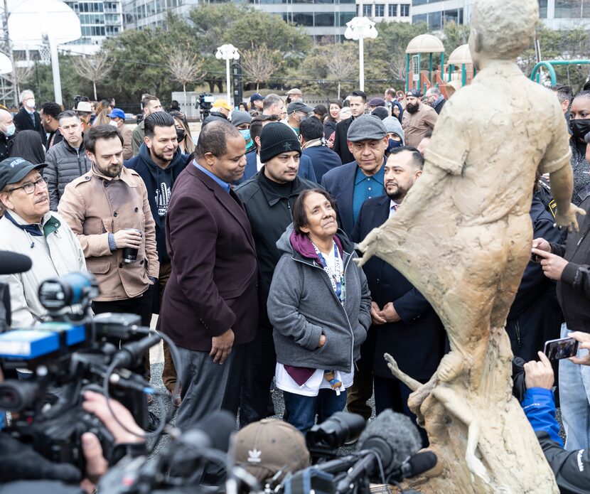 Bessie Rodriguez looks up at the sculpture celebrating the life of her 12-year old son,...