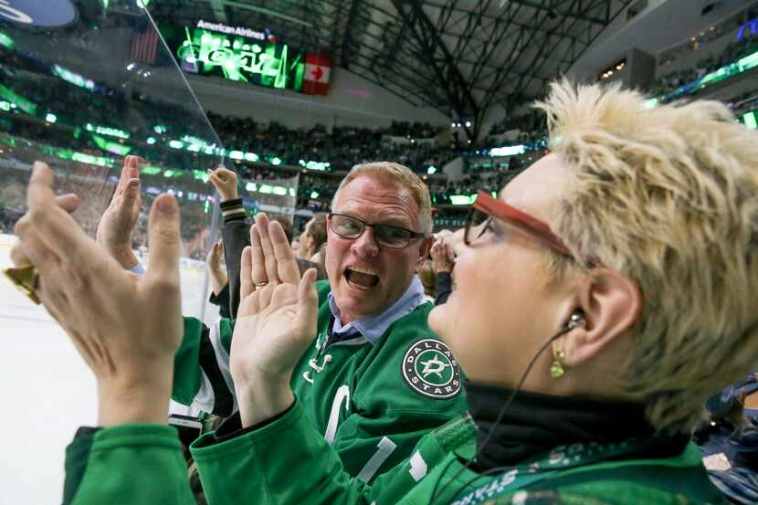 Chris Brickman celebrates with his wife, Cindy Brickman, after the Stars scored a goal...