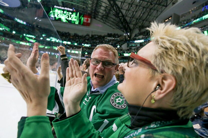 Chris Brickman celebrates with his wife, Cindy Brickman, after the Stars scored a goal...