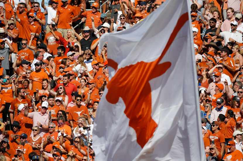 Texas fans cheer for their team during the first half of an NCAA college football game...