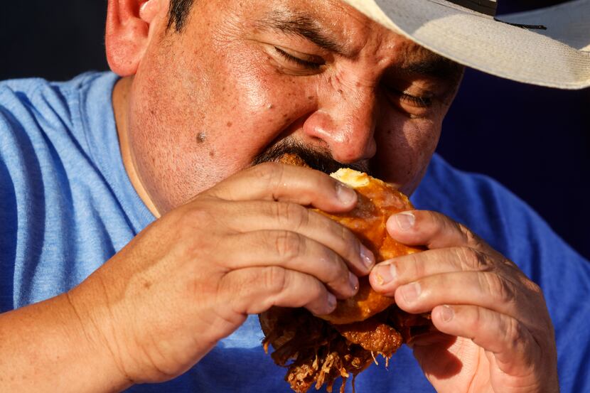 Guillermo Rodriguez samples the Holy Biscuit, one of the Big Tex Choice Award finalists,...