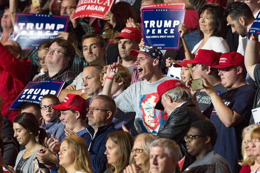 Supporters of Republican presidential candidate Donald Trump cheer during a campaign rally,...