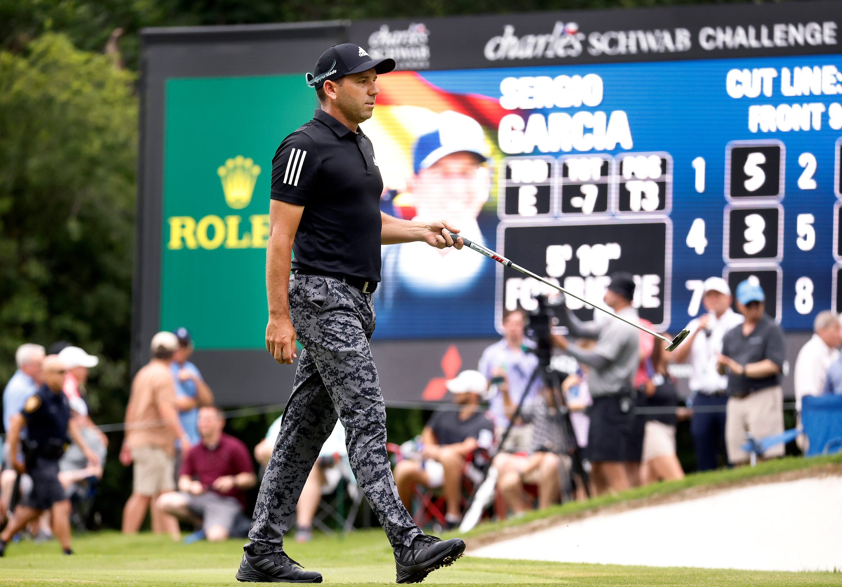 Professional golfer Sergio Garcia walks off the No. 8 green after putting for birdie during...