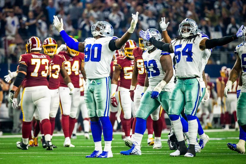 Dallas Cowboys defensive end Demarcus Lawrence (90) celebrates with middle linebacker Jaylon...
