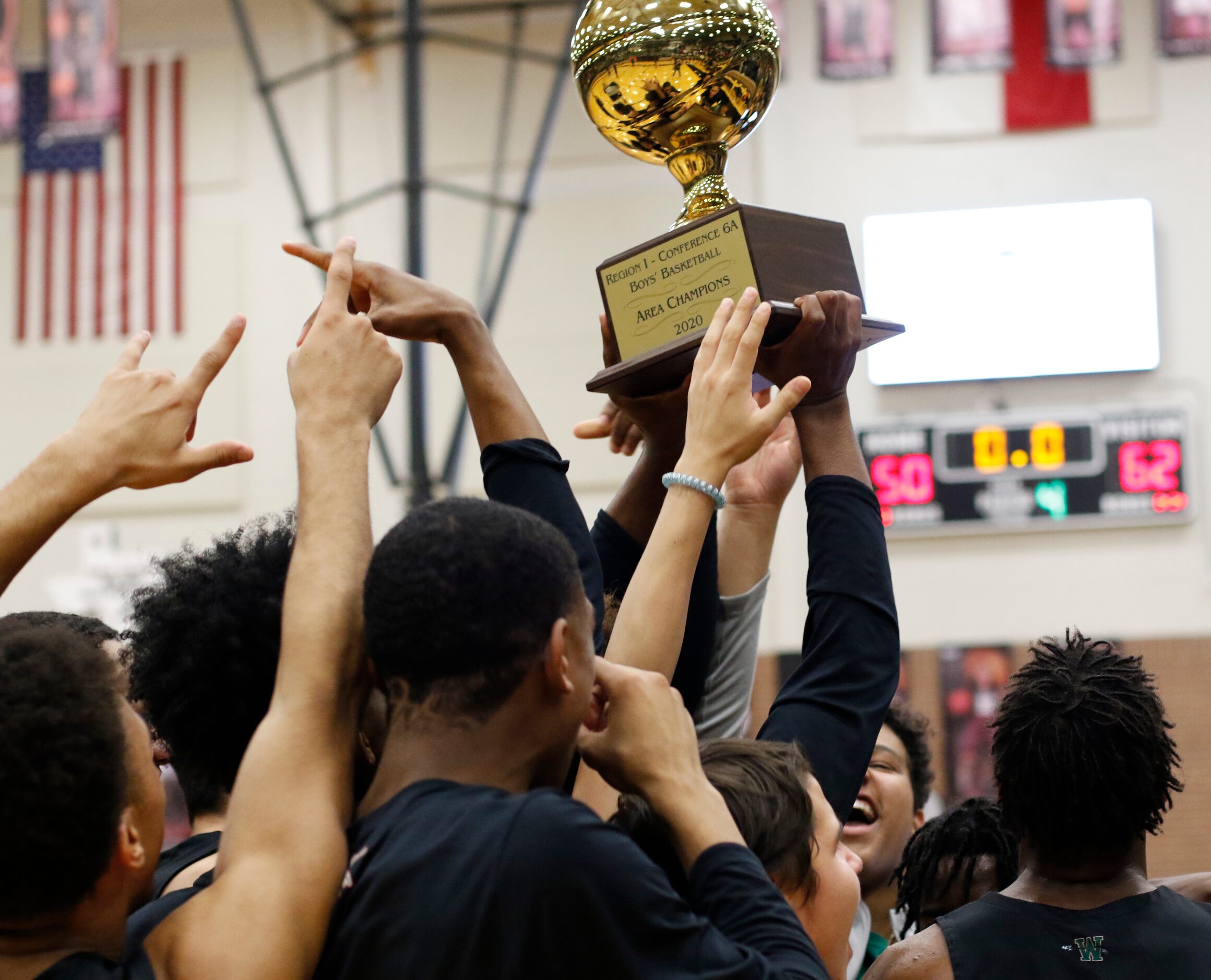 Members of the Waxahachie Indians celebrate with their Class 6A Region 1 Area Champions...