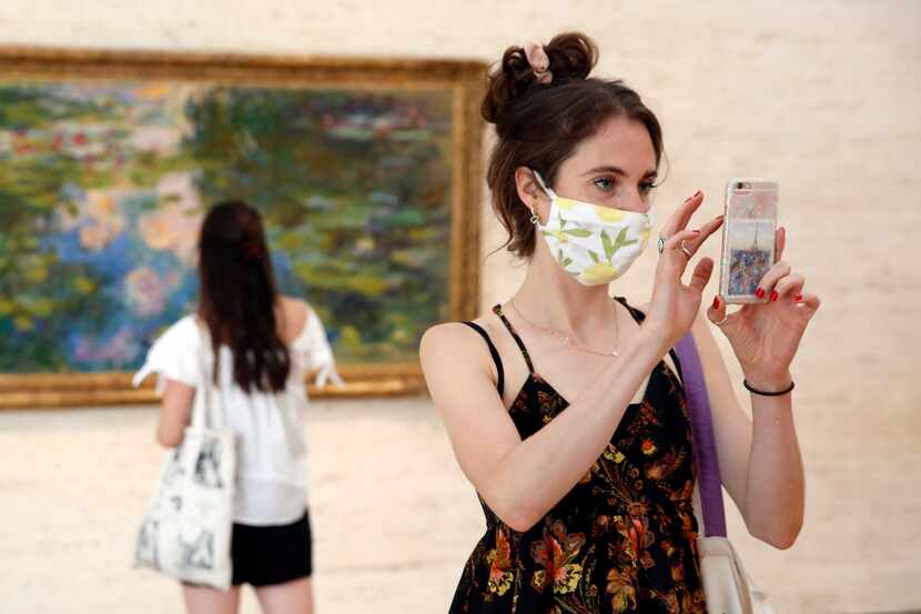 Libby Krueger of Fort Worth takes a photo of paintings in the Kimball Art Museum as her...