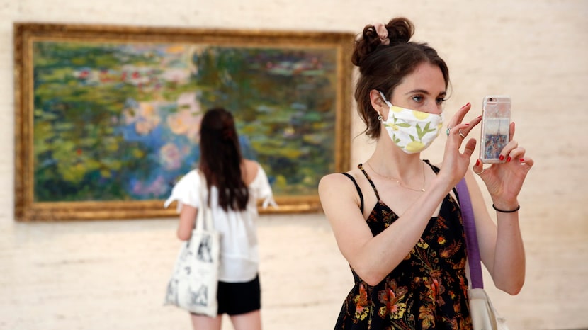 Libby Krueger of Fort Worth takes a photo of paintings in the Kimbell Art Museum as her...