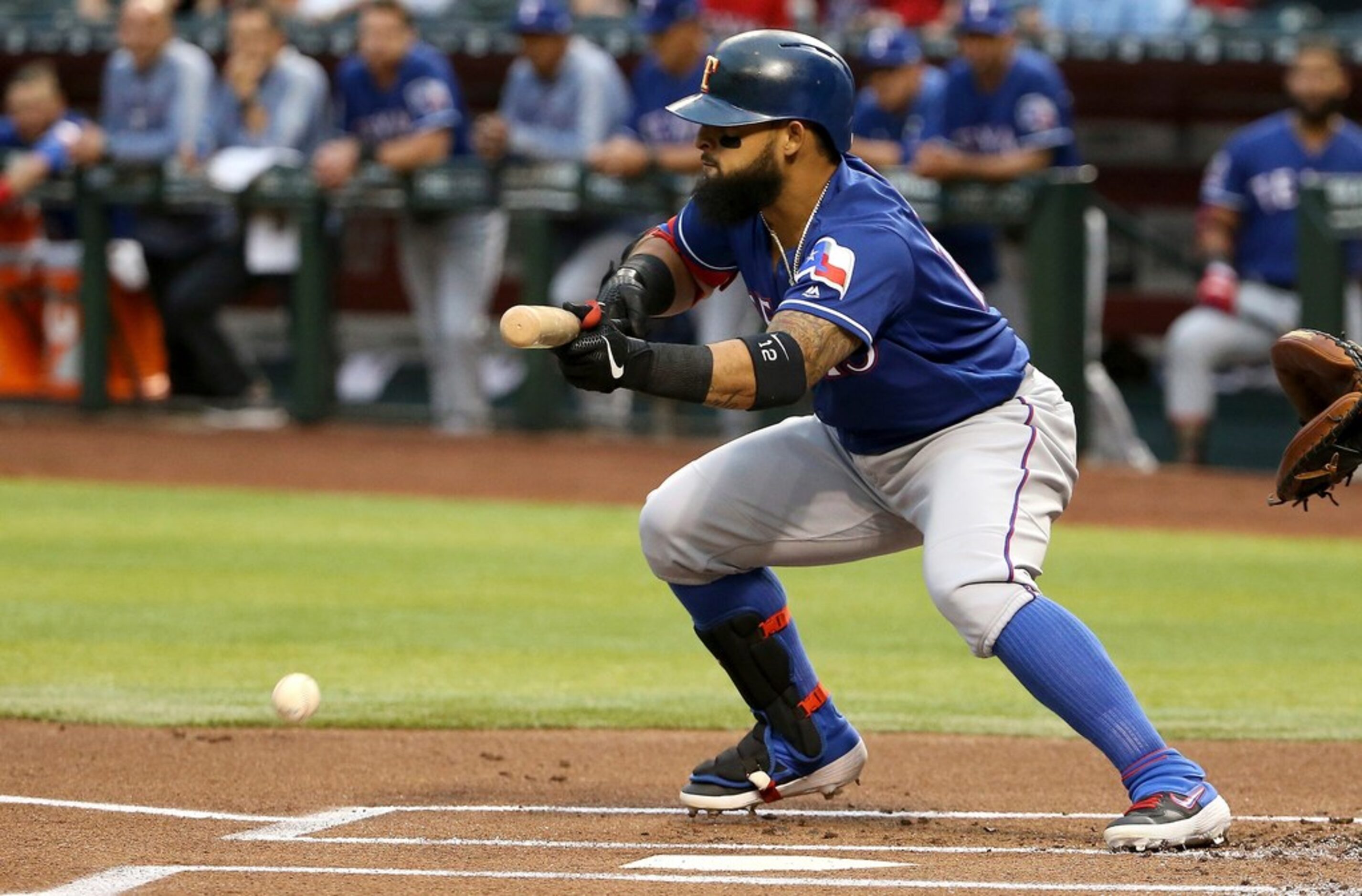 Texas Rangers' Rougned Odor lays down a bunt against the Arizona Diamondbacks during the...