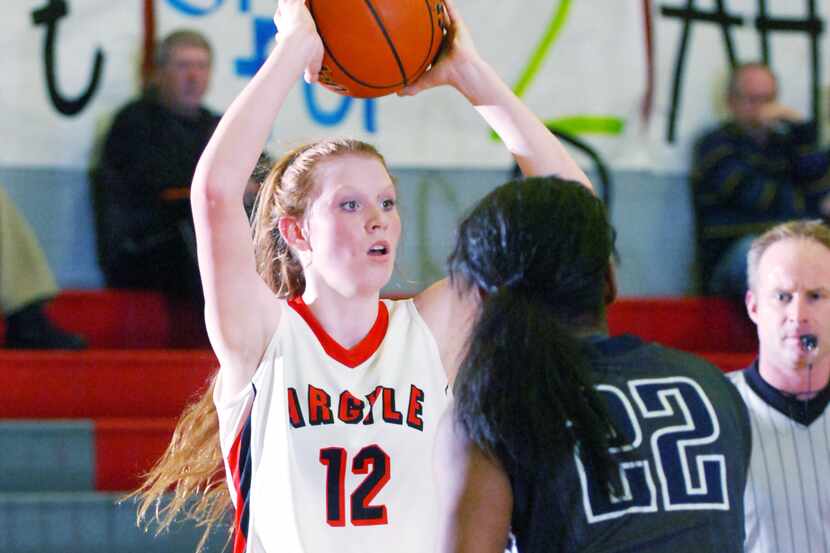 Argyle freshman guard Vivian Gray (12) looks to pass out of a corner against Frisco Lone...